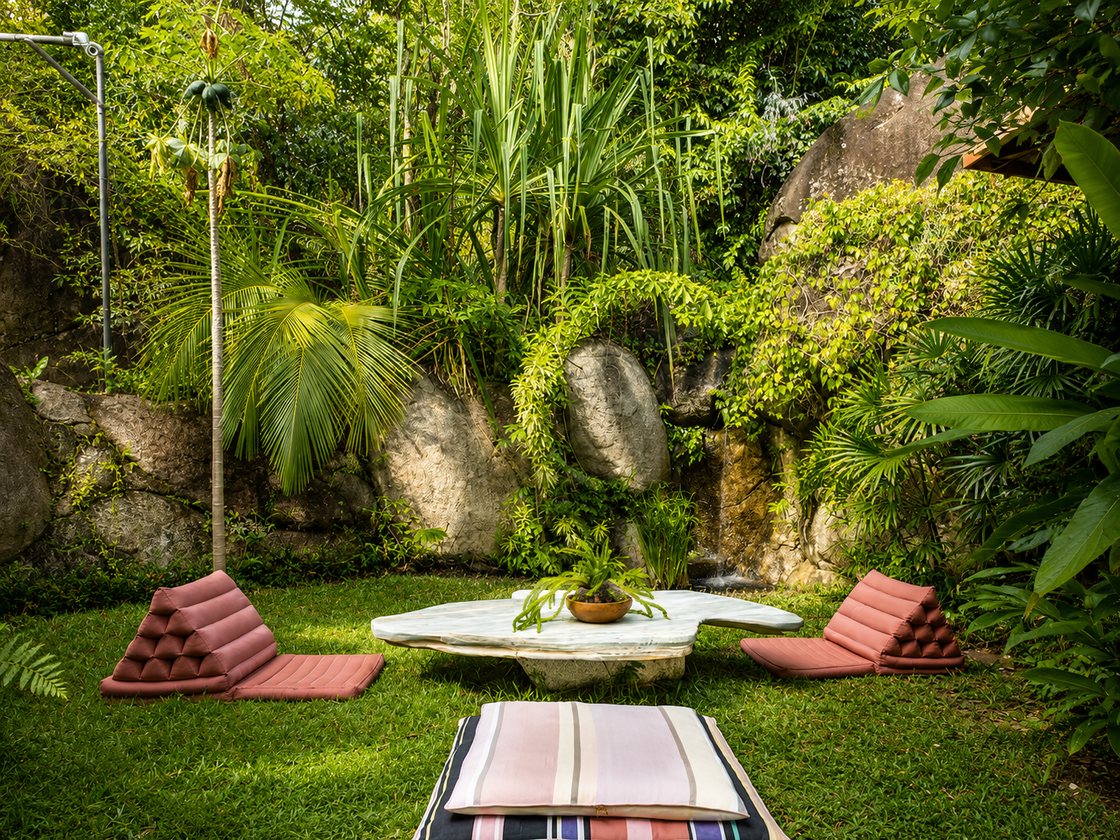 Garden lounge with Thai cushions and stone table