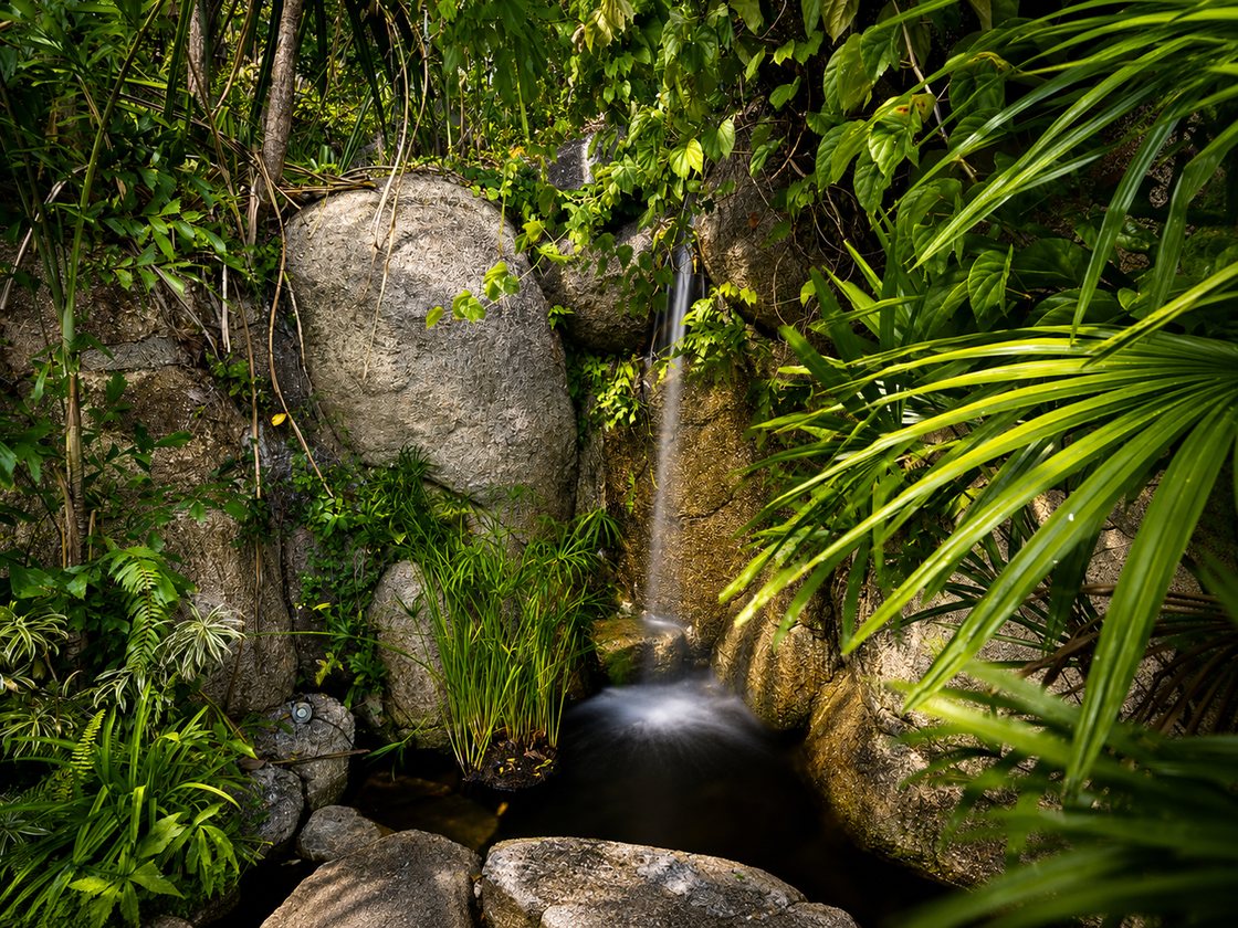 Waterfall flowing over boulders in the garden