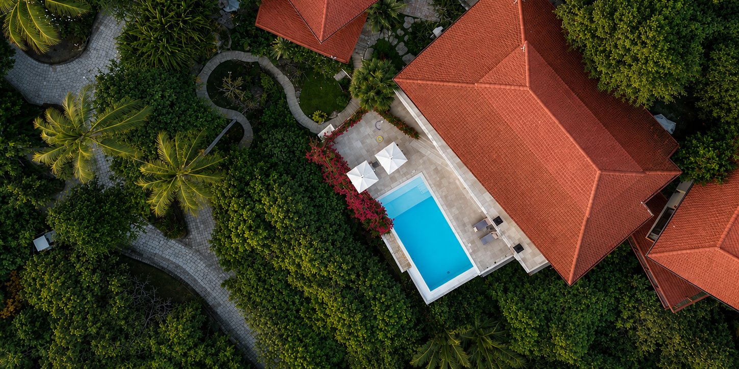Drone view of the Villa Soluna estate rooftops and pool from above