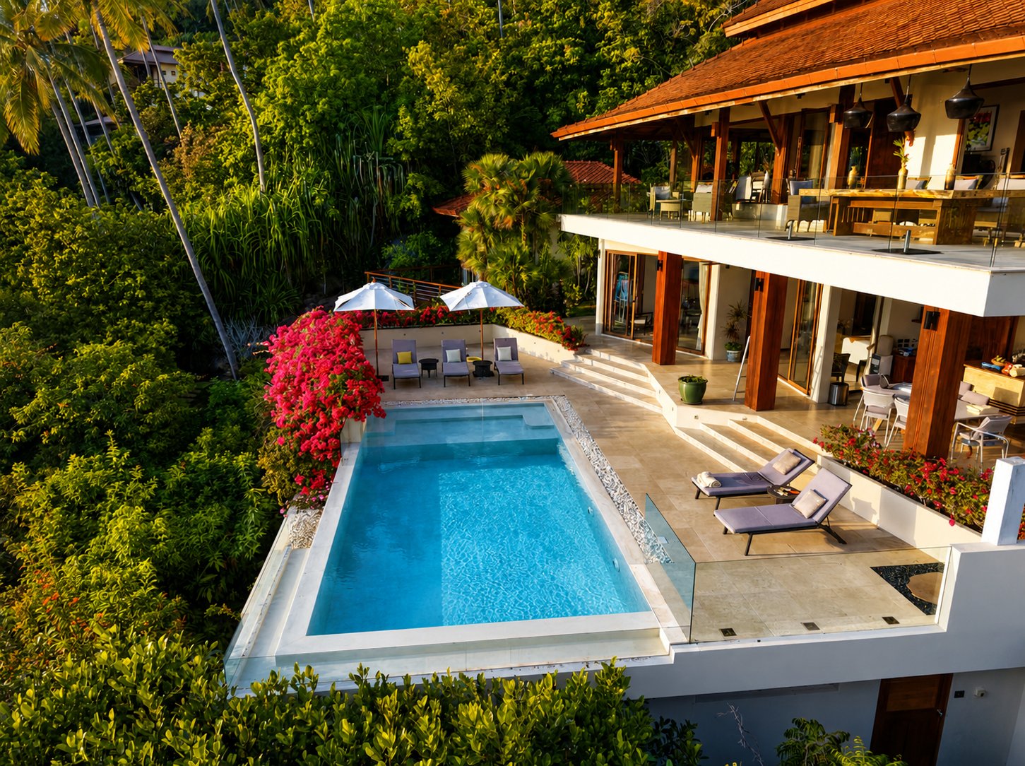Aerial view of Villa Soluna estate with infinity pool surrounded by jungle