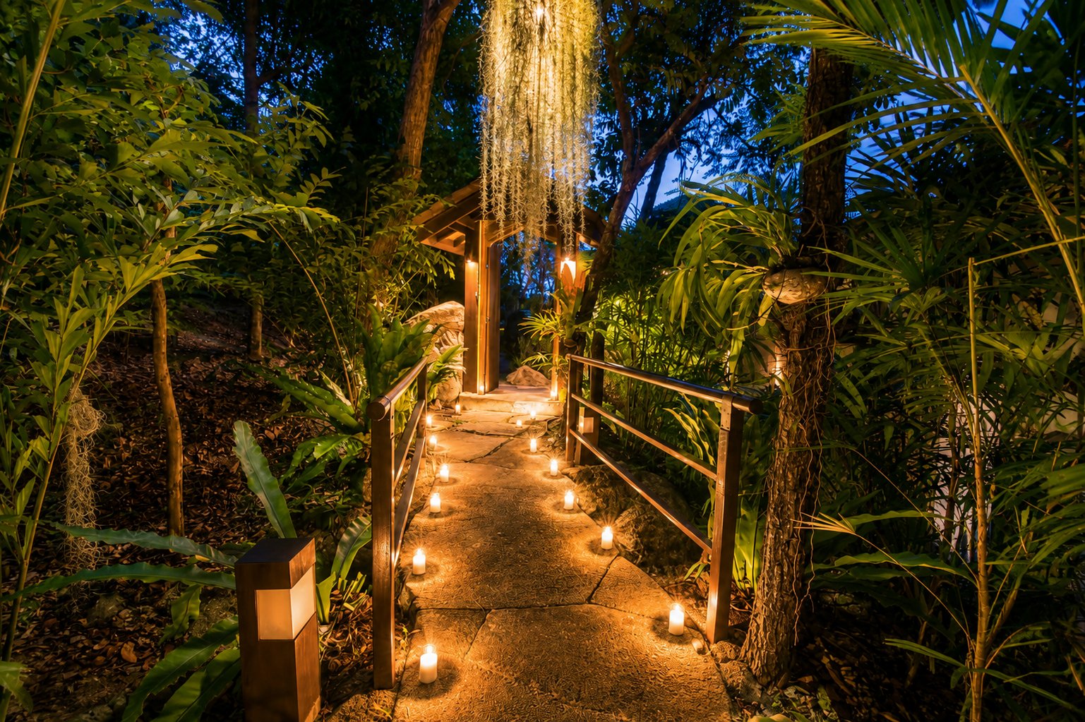 Candlelit garden pathway through the jungle at night