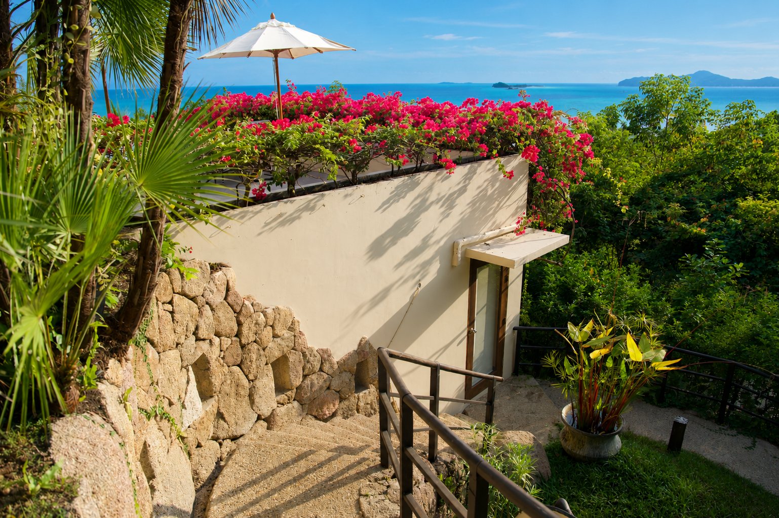 The Hideaway private entrance with bougainvillea and sea views